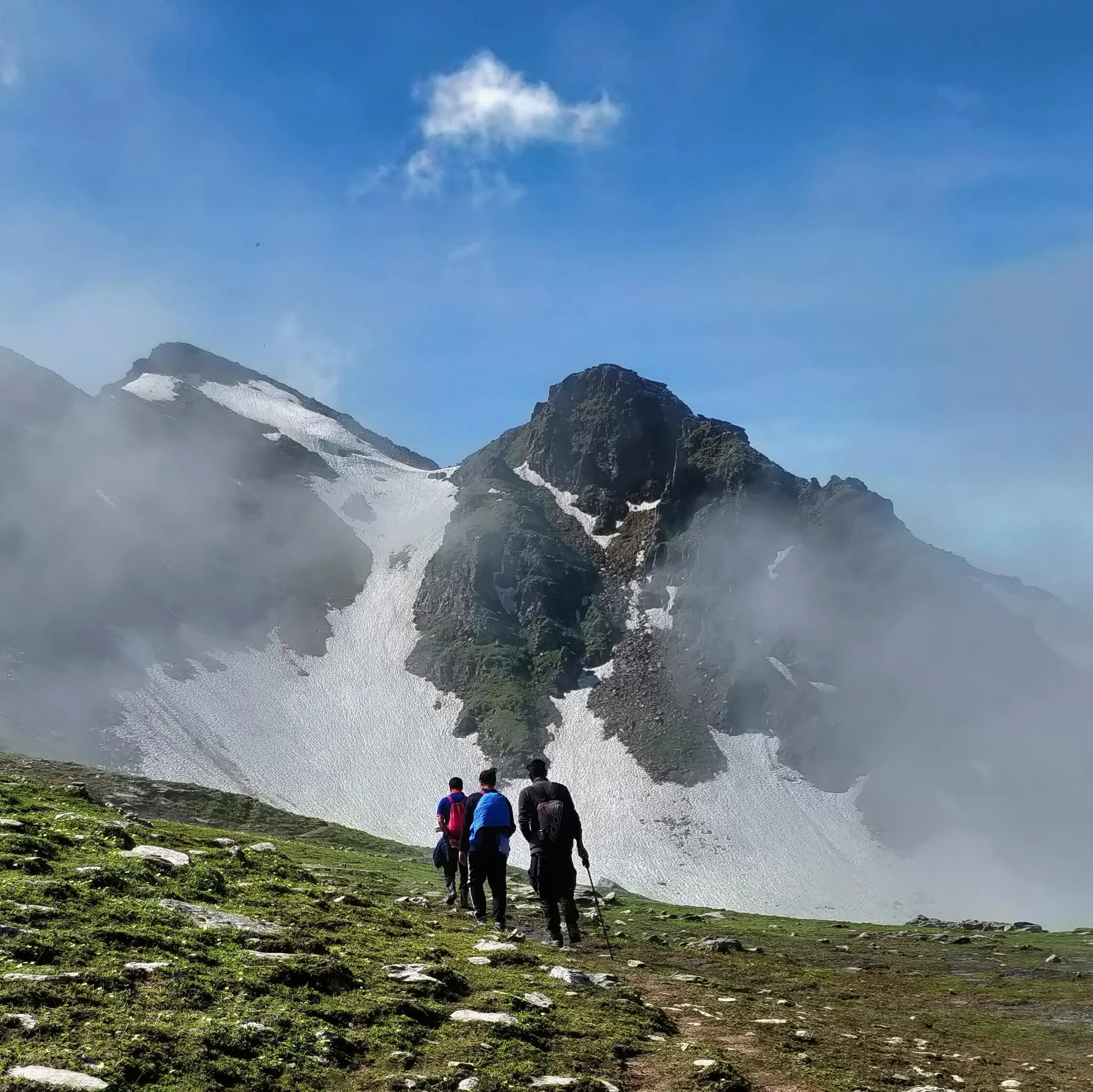 Summit climb with snow covered mountains in the background