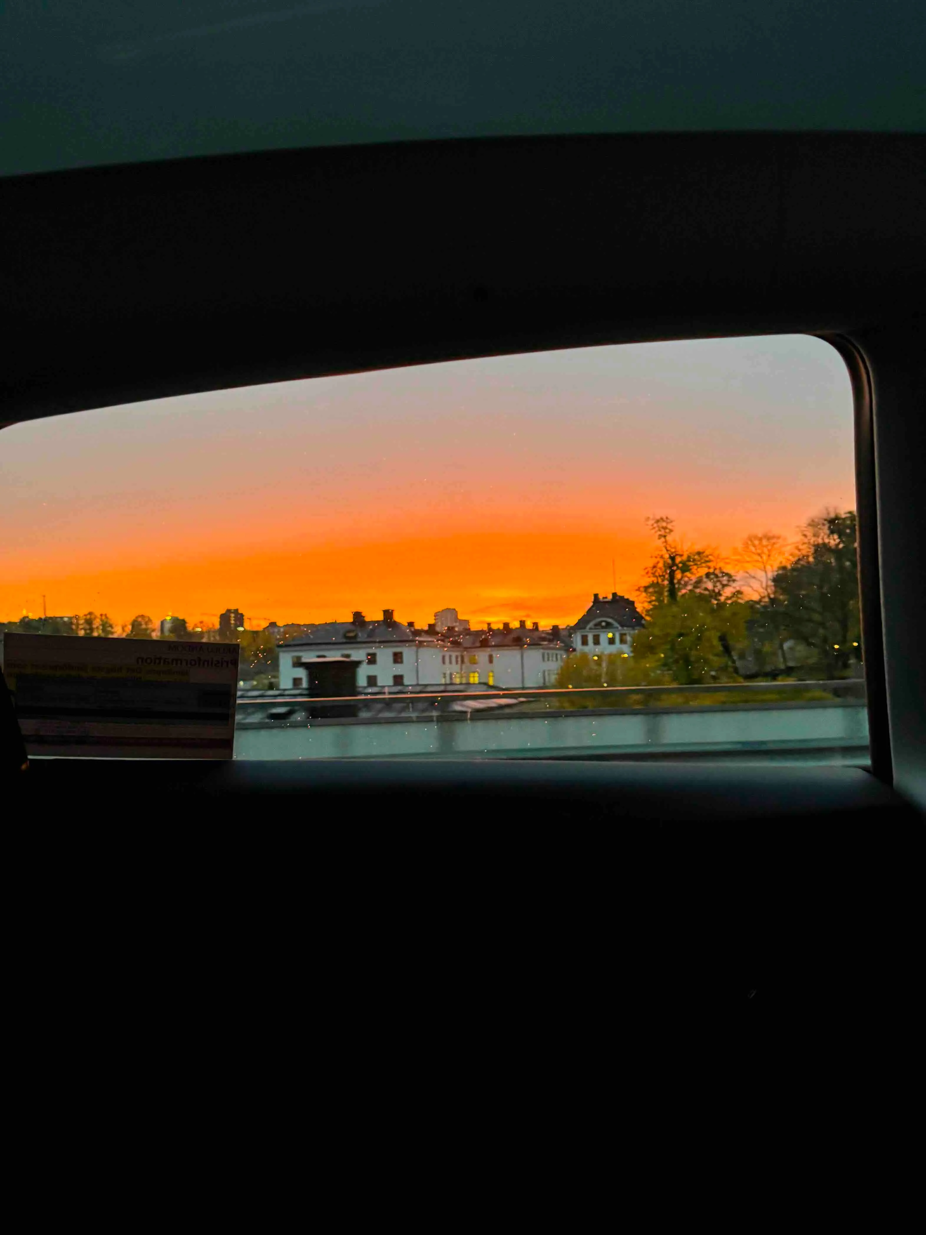 Sunset view over Solna from the window of a moving car