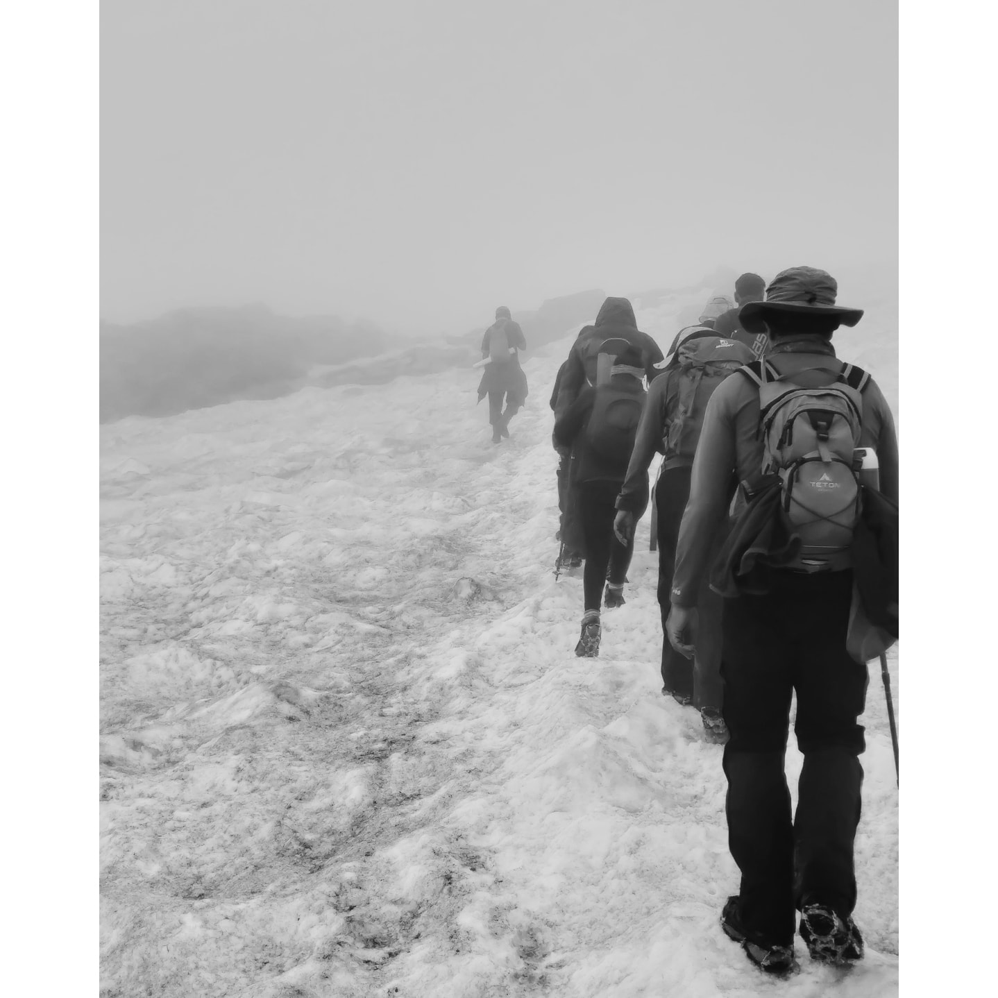 Bhrigu Lake trekkers walking on snow through a whiteout